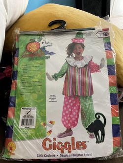Child Clown Costume in a clear plastic package featuring a colorful rainbow-striped shirt and split pink-and-green polka-dot pants.
