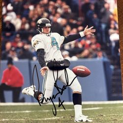 Autographed photo signed in black marker by football player number four color 8” x 10”