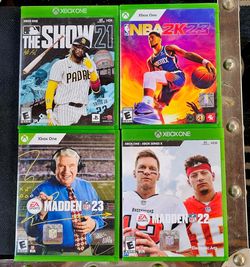 collection of four physical sports video game cases for Xbox One and Xbox Series X, including MLB The Show 21, NBA 2K23, Madden NFL 23, and Madden NFL