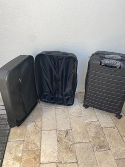 Two new large black suitcases