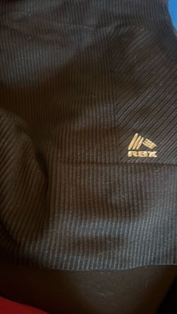 This RBX active hoodie features a black ribbed fabric and a contrasting white logo.