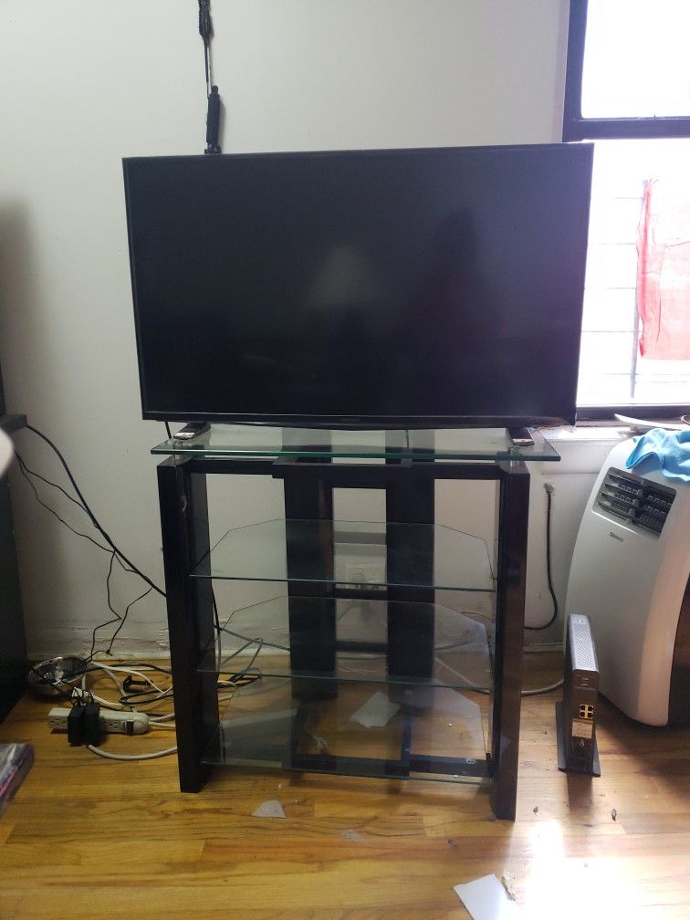 Flatscreen Tv With A Glass Stand 