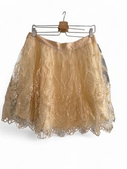 NK pastel yellow lace mini skirt features an intricate floral embroidered overlay with a delicate scalloped hemline size M