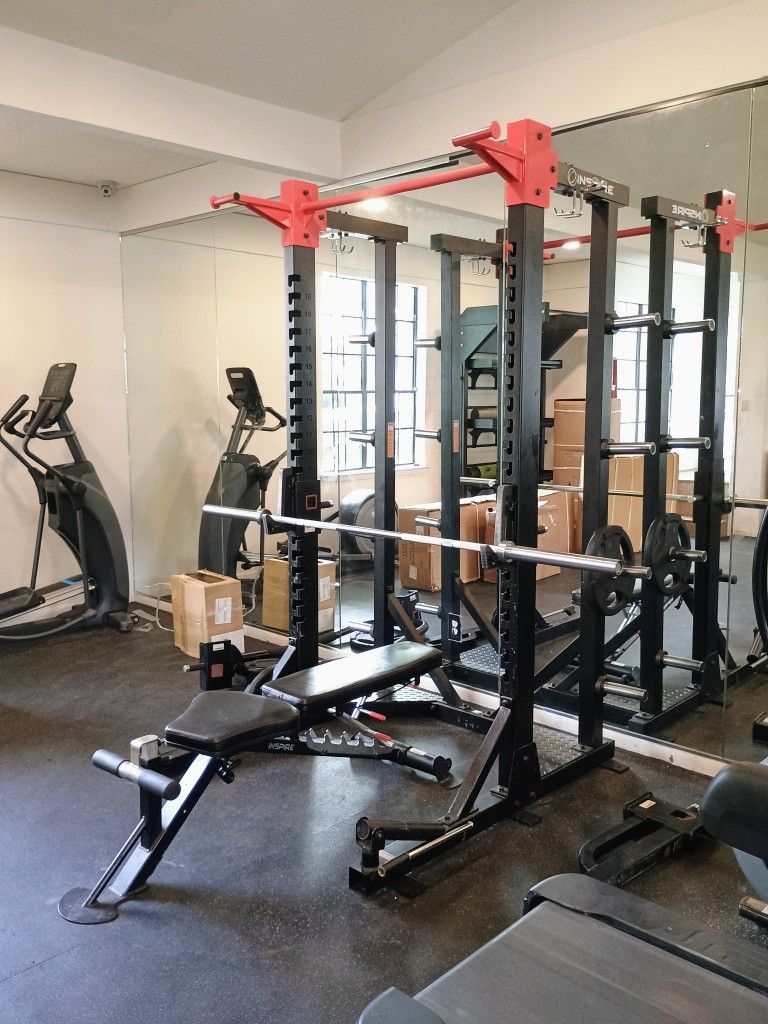 Used Commercial Half Rack W Bar And Some Weight Plates