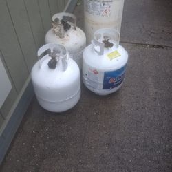 4 propane tanks 3 -5gallon tanks and a 12 gal.