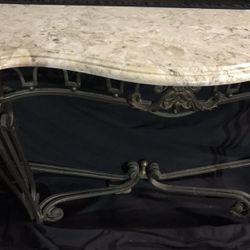 Wrought-iron table with marble top