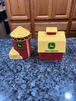 Ceramic John Deere Barn & Silo Pair of salt and pepper shakers. Brand new never used with stickers on the bottom. Has been on display in a cabinet w