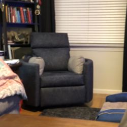 Jordan’s Furniture swiveling recliner chair. 