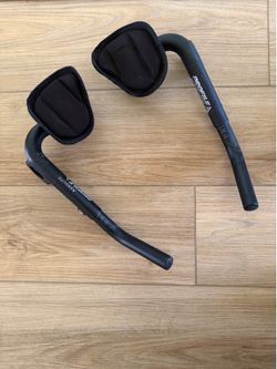 Bicycle Accessory: Aerobar with armrest positions cyclist in the most aerodynamic position to maximize speed.