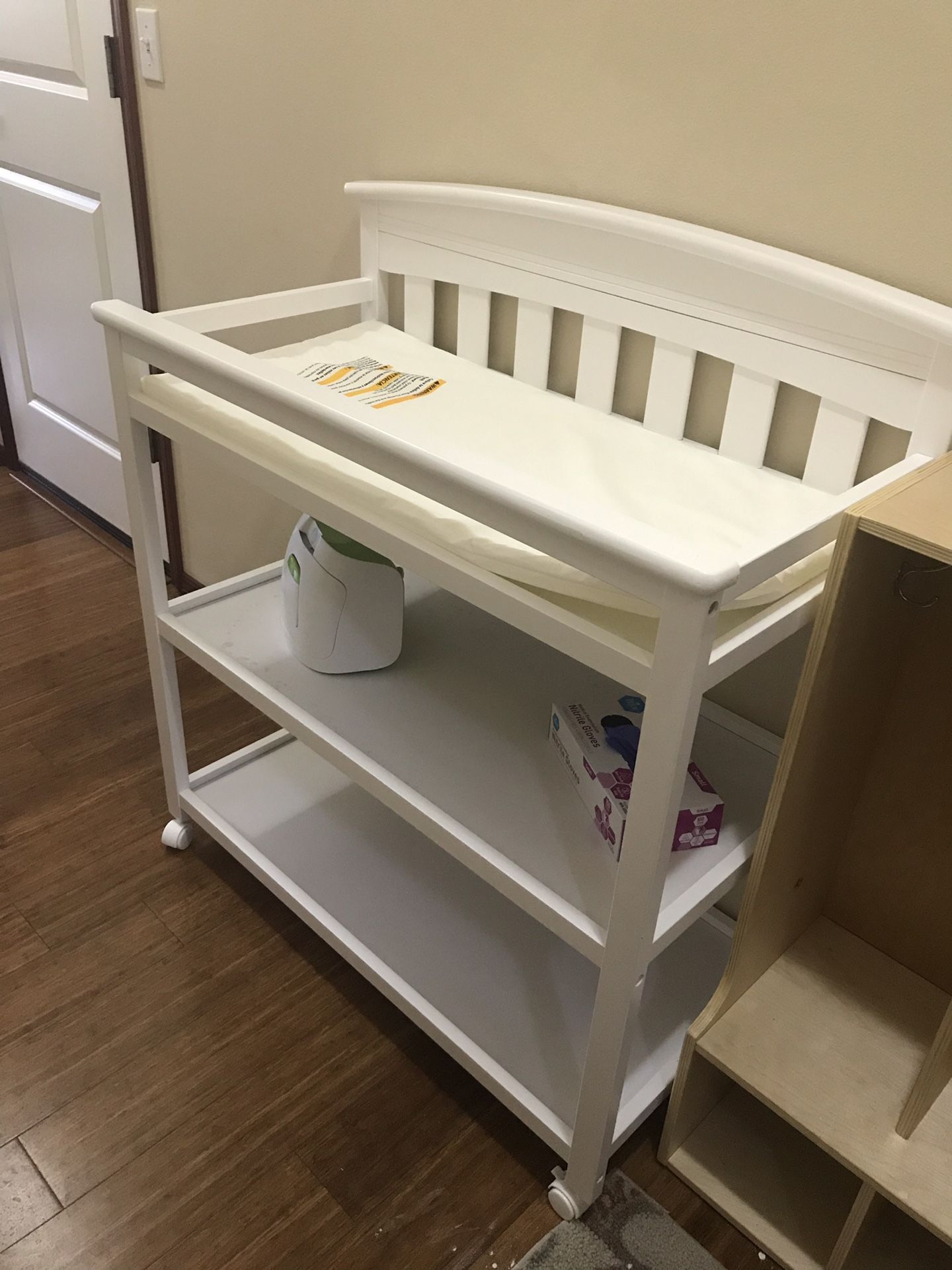 White baby changing table on wheels