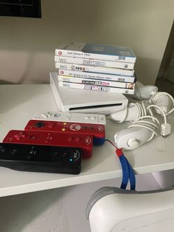 Nintendo Wii Bundle w/ 4 Controllers and nunchuks, Wii Fit Board, 7 Games