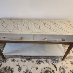 grey solid wood console table with drawers and shelf.
