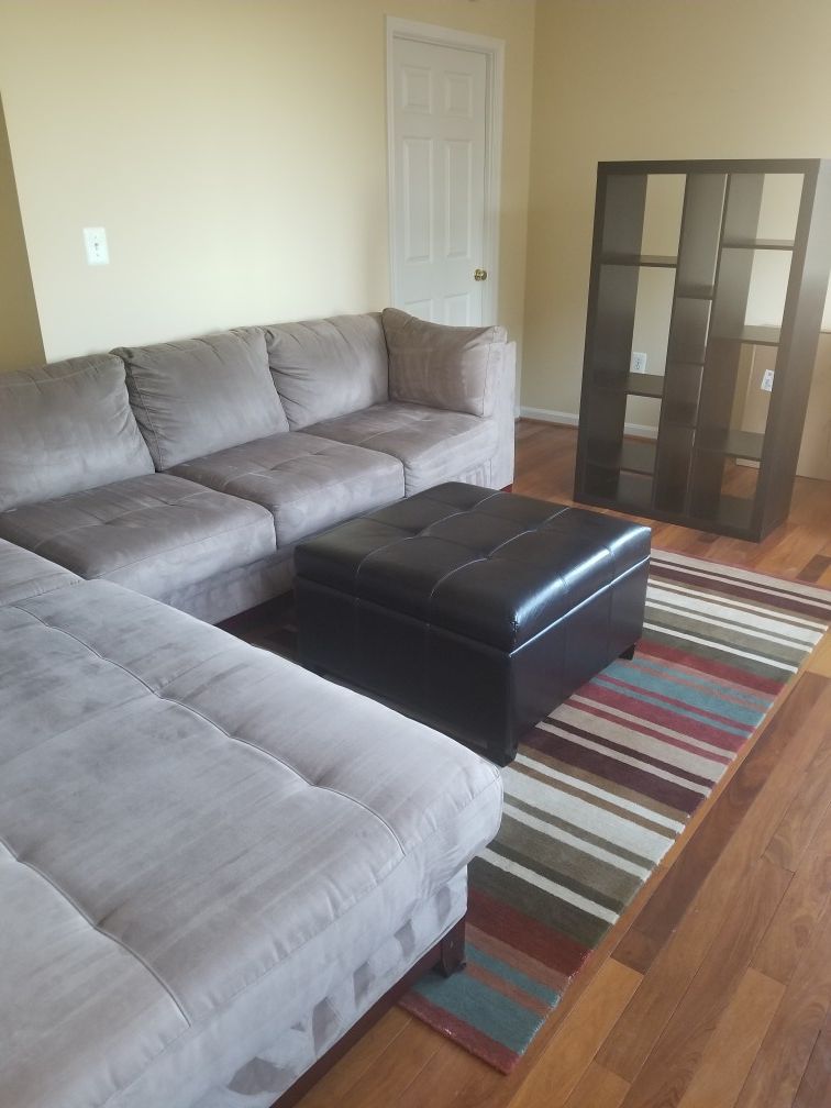 Living room set - sectional couch, rug, ottoman, bookcase, & TV stand