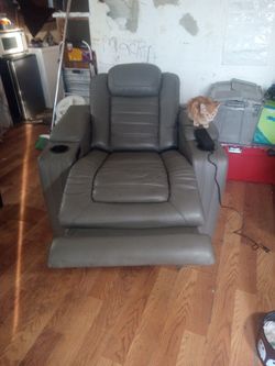 Orthopedic Leather Chair With Massage And Warmth Adjustments And A Phone Charger On It