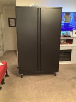 Black metal wide and deep cabinet.dimensions height 72 inches width 43 inches depth 20 inches