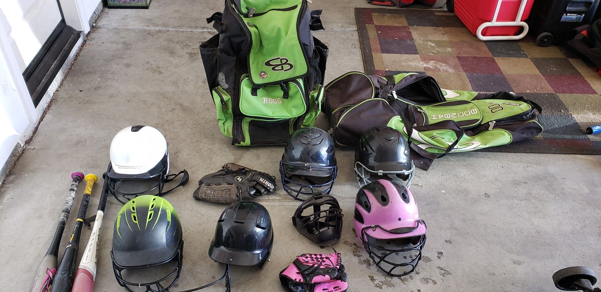 Softball gloves, bats, helmets and bags