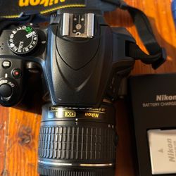 Nikon D 3400 camera bundle with two lenses and neck strap