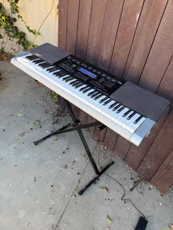 Casio full size keyboard WK-240. Works great. Stand included