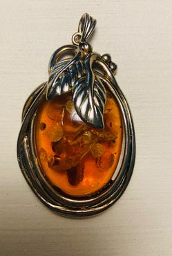 Amber pendant with stainless steel bezel