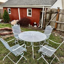Wrought iron patio set, table and 4 bouncy spring chairs