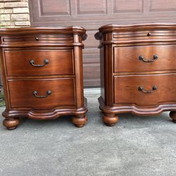Two 2-drawer solid wood nightstands with pull out tray