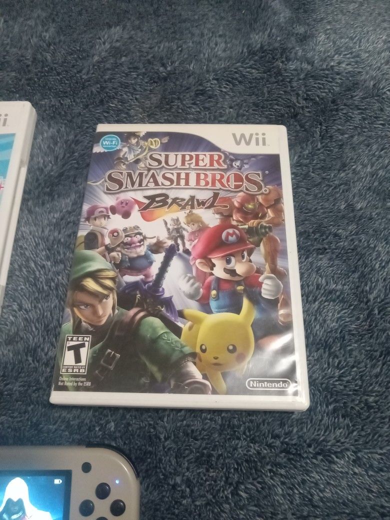 2 Nintendo Wii Games Super Smashbros And Super Paper Mario And A Hand Game Lot Of Games In It All For $20.00 Dollar 