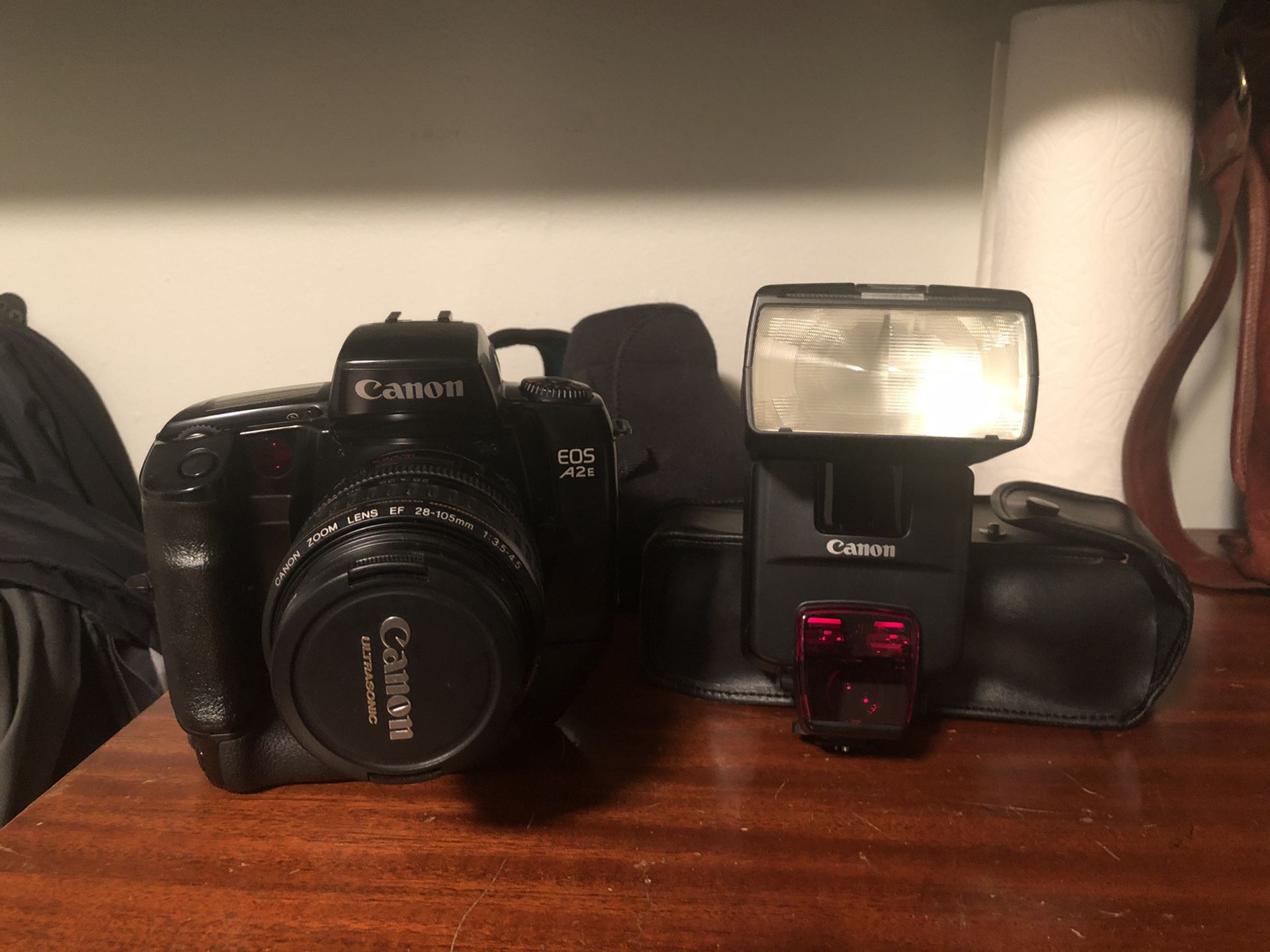 Canon A2e film camera with complete setup which includes: 550EX Speedlite flash, VG-10 motorized vertical grip, and Canon Ultrasonic 28-105 AF Lens