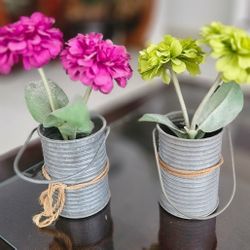 Beautiful Silk flowers are in a small iron bucket, two for $10