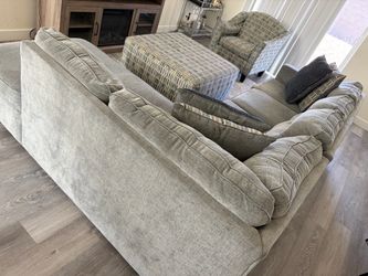 Large Gray Sectional Sofa with Throw Pillows includes the sectional, ottoman, matching chair.