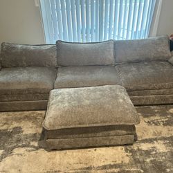 gray 3 seat couch and ottoman. 