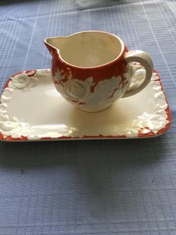 Orange and white pitcher and plate