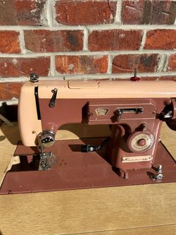 Vintage Kenmore sewing machine with mauve colored cabinet