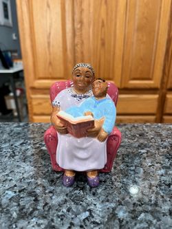 Bedtime Story Clay Art Year 2000 Ceramic pair of salt and pepper shakers. Brand new never used. There are no white spots on the shakers the lighting