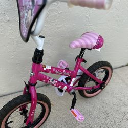 Huffy Disney Minnie Mouse 12-inch Kids' Bike, designed for young children, typically ages 3 to 5 years old and between 37 to 42 inches in height.