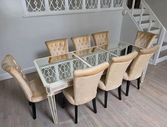Mirrored glass table with 8 upholstered cusioned chairs