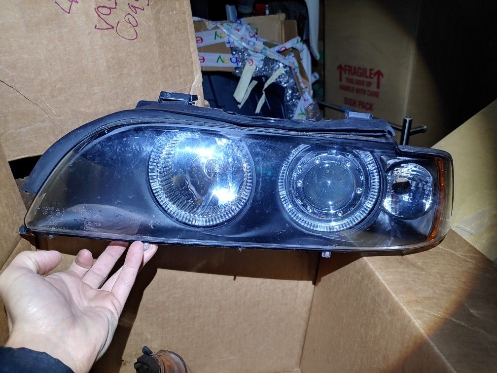 Bmw e39 5 Series aftermarket headlights with halo rings.