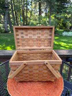 Vintage picnic basket with folding handles and hinged lid