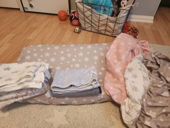 Clean baby changing pad and covers.  Baby blankets for swaddleing.