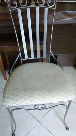 Glass dining table with 4 iron chairs.