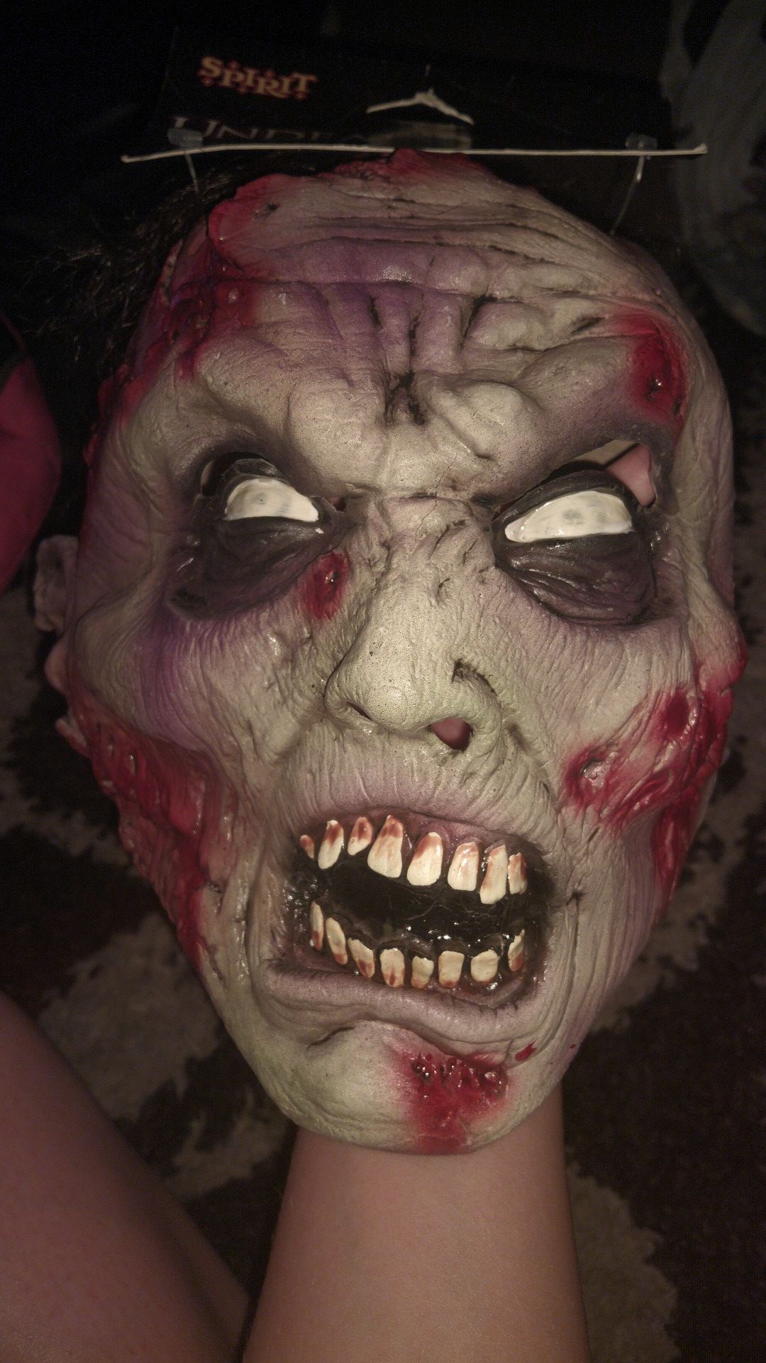 Zombie mask with brains showing and strains of hair costume