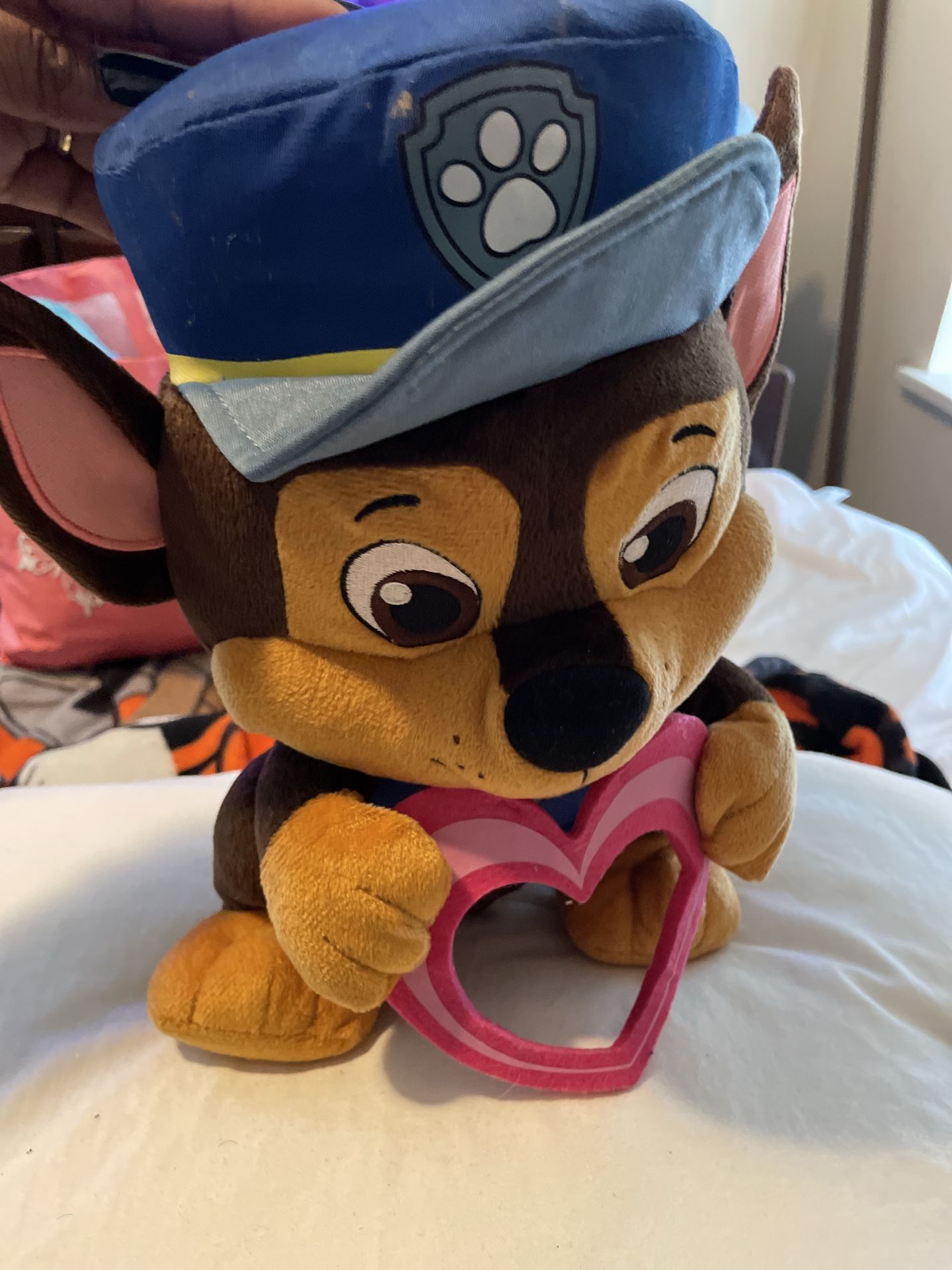 A full-size paw patrol Chase plush figure