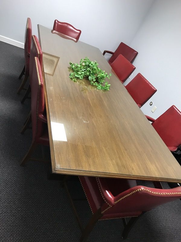 Conference table with 10 red leather chairs