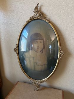 Ornate Antique metal picture frame with curved glass