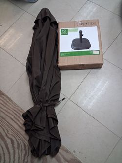 Dark brown umbrella and concrete umbrella base, black.
Both new condition, just