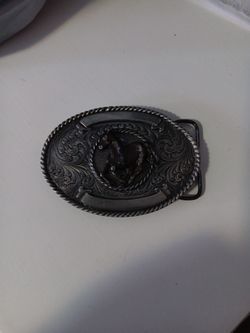 A man's brass cowboy buckle