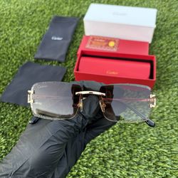 Gold Cartier glasses with black/yellow lenses