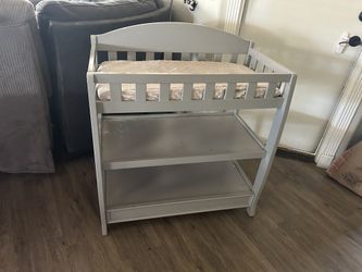 Baby changing table with pad and sheet