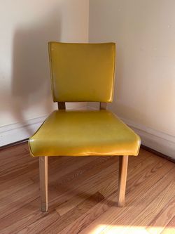 Mid century vinyl accent chair in yellow