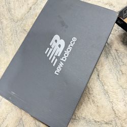 pair of New Balance 530 sneakers in white with pink sugar and silver metallic accents. 