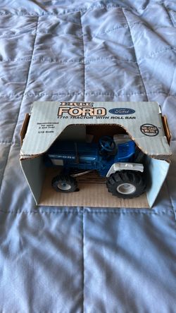 Scale model Ford Tractors in original packaging